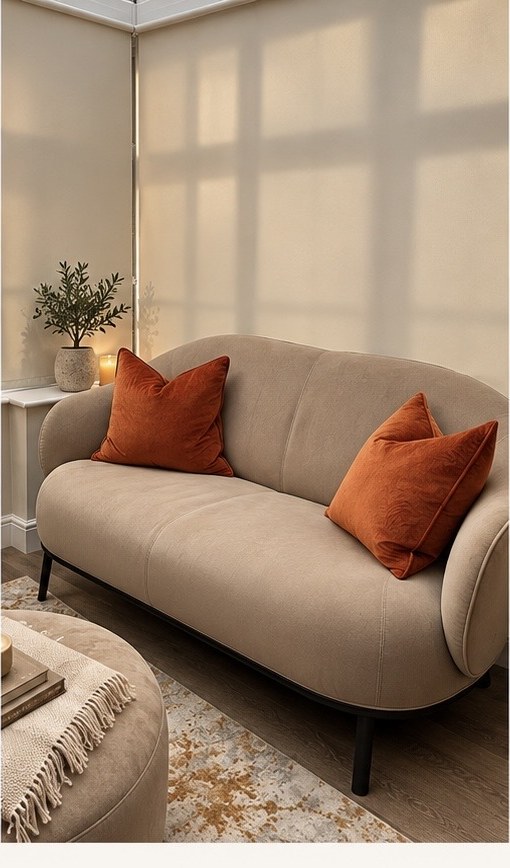 Cream sofa with rust velvet cushions and warm natural light